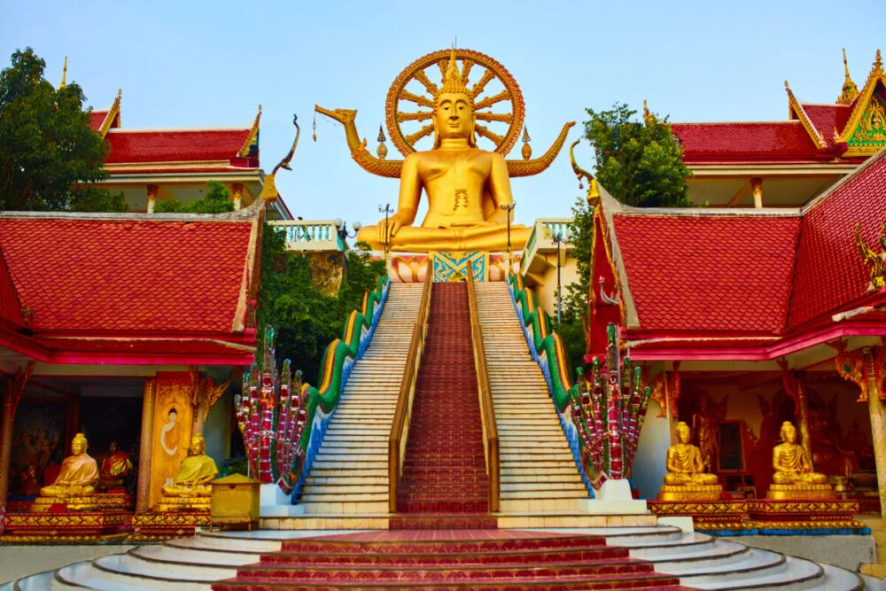 Golden Statue Of Buddha With Dragon Staircase In Wat Phra Yai, The Big Buddha Temple At Koh Samui. Place For Praying, Meditation. Buddhism. Religious Symbol. Travel, Tourism.