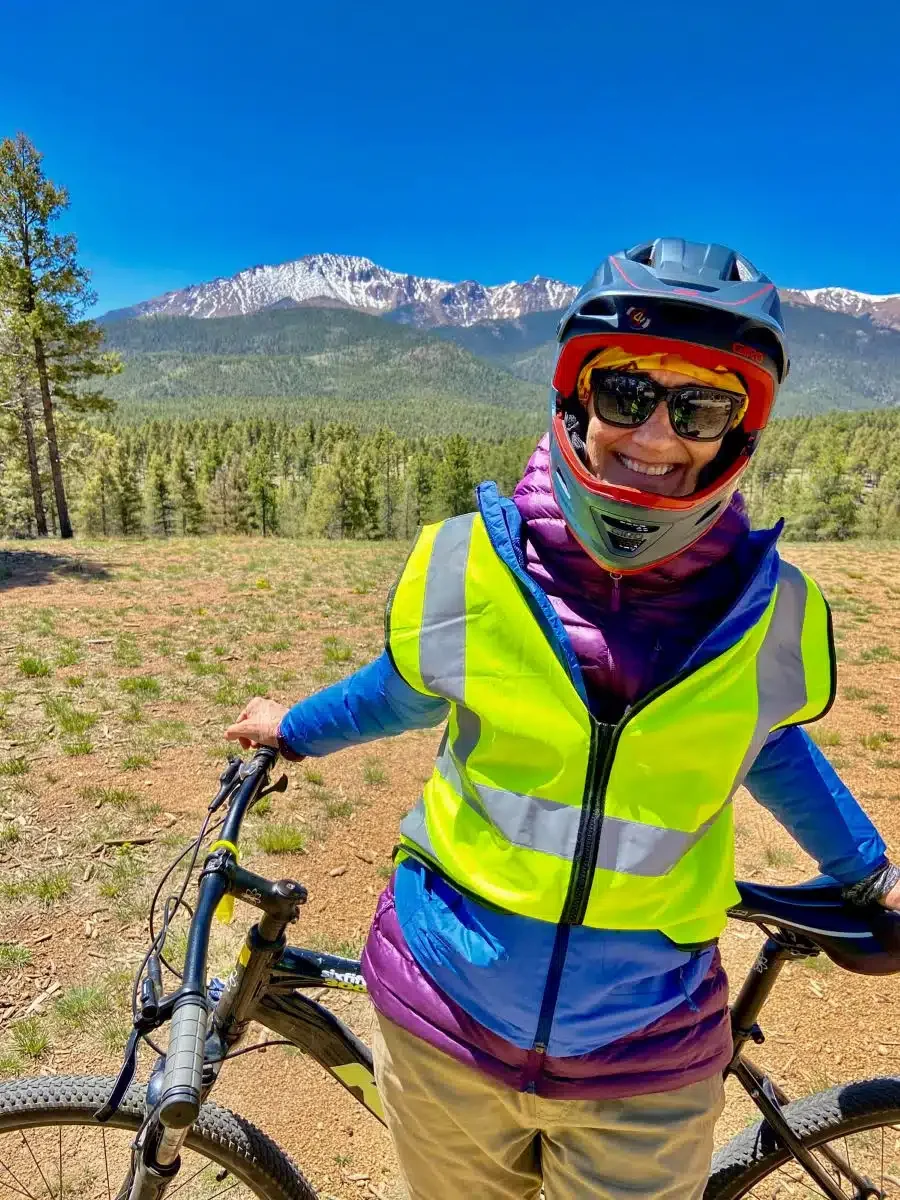 Photo of the author standing near her bike for her bicycling adventure down Pikes Peak.