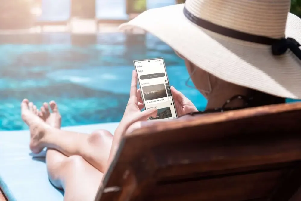 woman at a pool with her phone