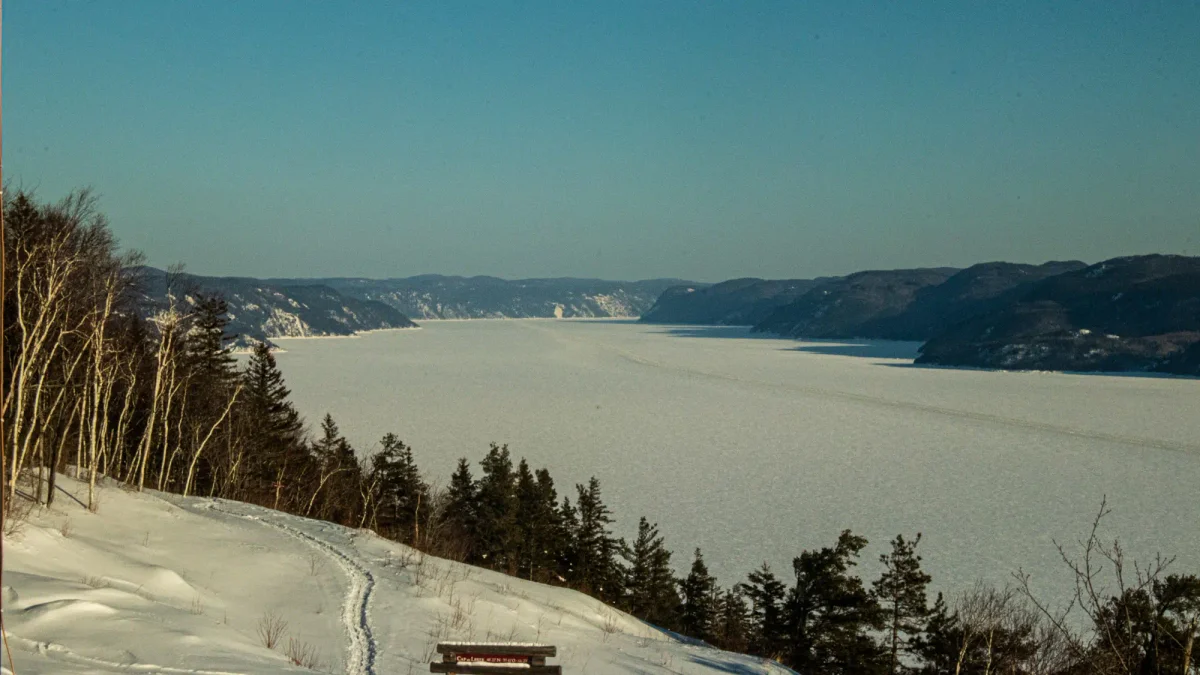 The world’s largest inland fjord, Saguenay Fjord is covered with a layer of ice. In the bays adjoining the fjord, the ice is more than two meters thick and supports large numbers of fishing shacks. In the main channel, and ice breaker smashes a channel in the center for commercial boat traffic. The view from Auberge Cap-de-Ouest is looking south towards the Saint Lawrence Seaway.