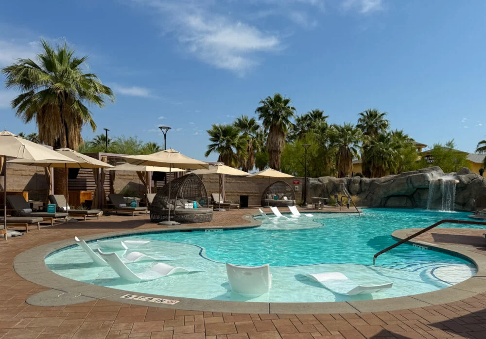 pool with umbrellas and cabanas