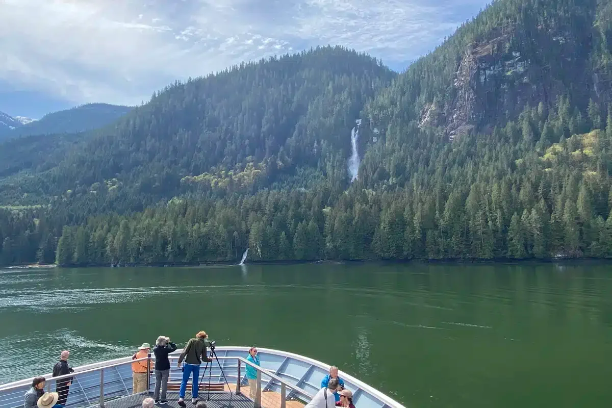 Guests on the bow of National Geographic Adventure.