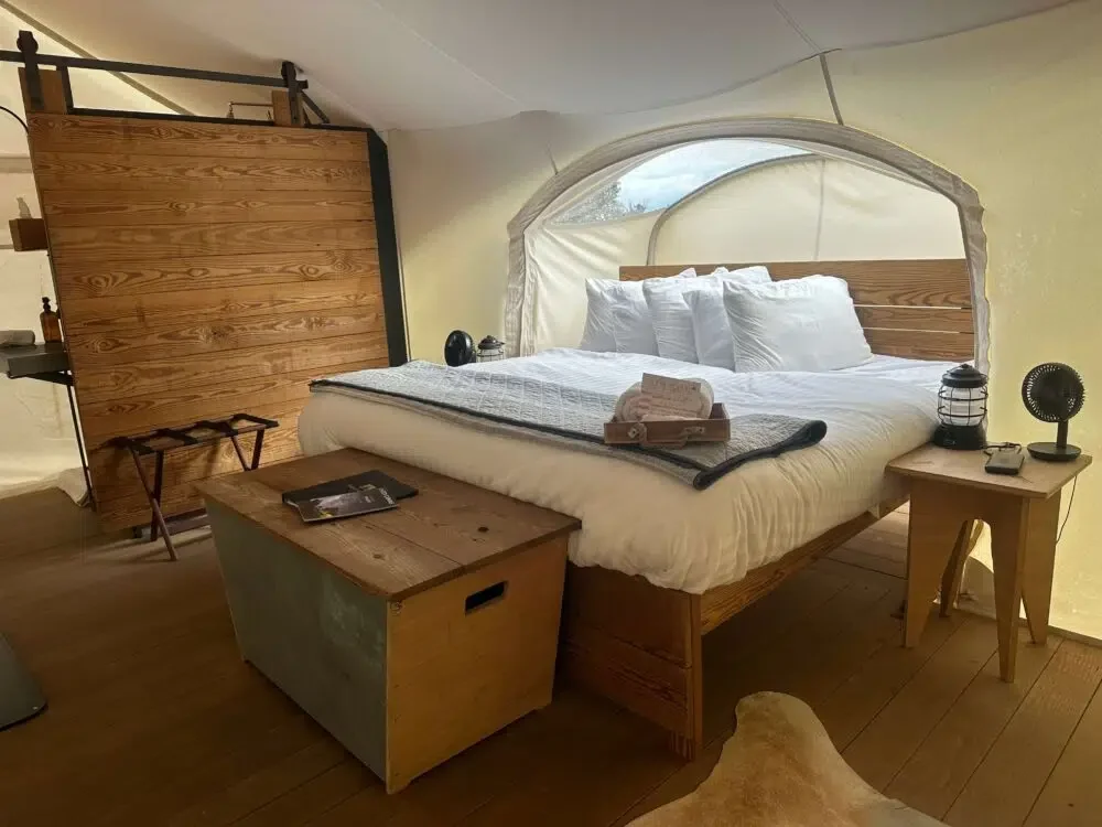 Under Canvas tents include comfortable beds, a bathroom with shower, battery-operated fans and lanterns, and a wood stove. Credit: Geri Koeppel