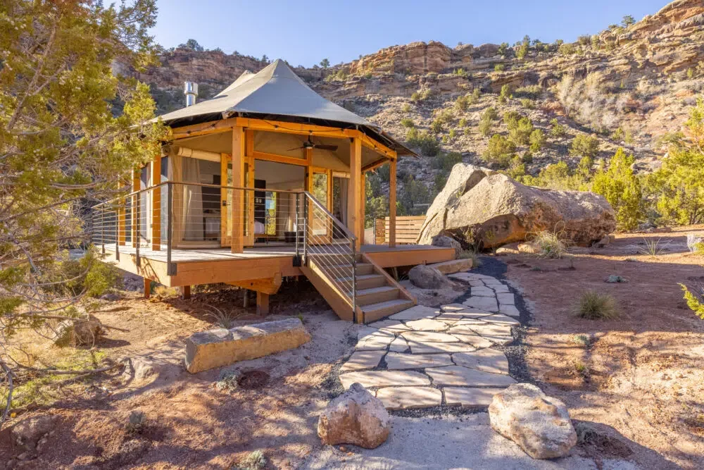 A glamping tent in a wilderness setting.