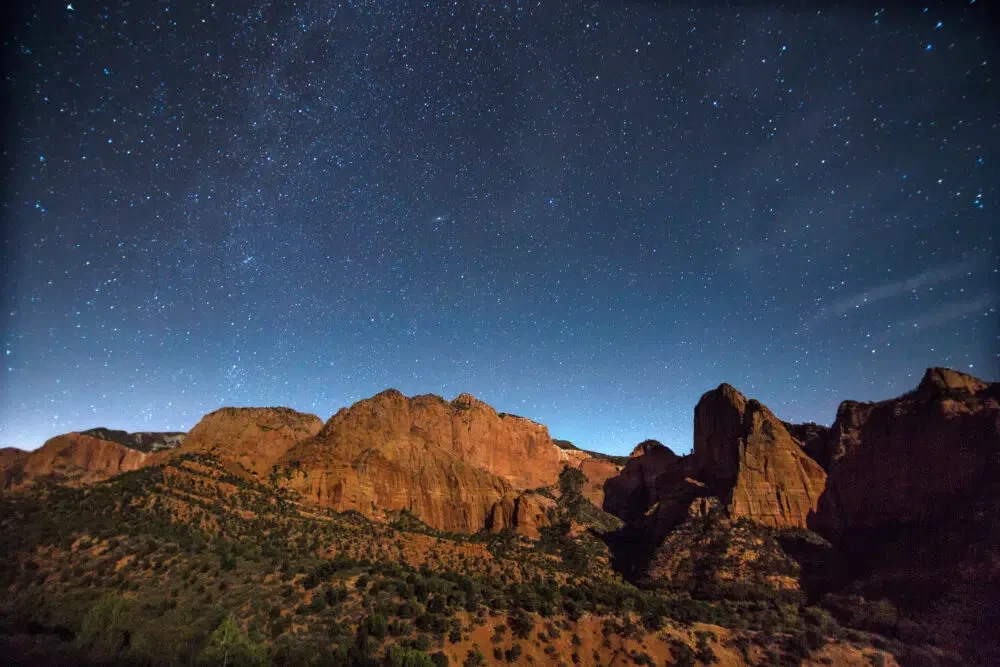 Stars in the night sky over rocky peaks