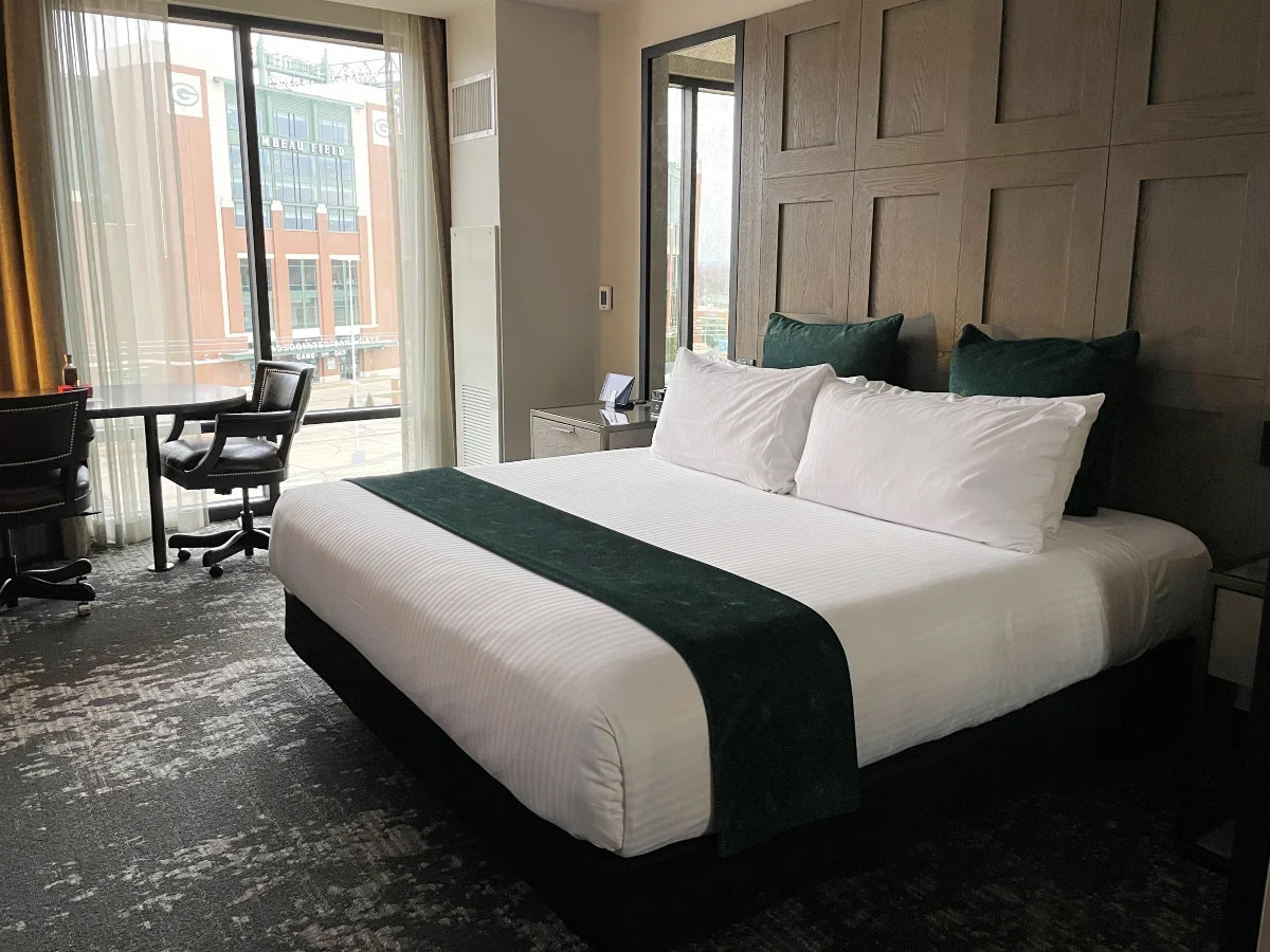 Lodge Kohler hotel room with a king-sized bed and window with a view of Lambeau Field.