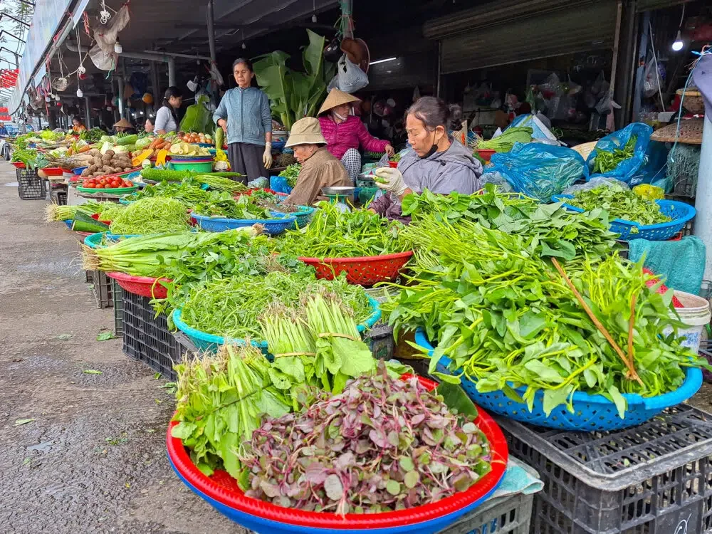 Outdoor fresh food section of Dong Ba Market. Trying new foods is one of the travel habits that improve your wellbeing.