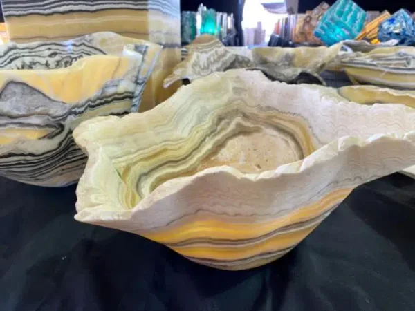 Carved stone bowls, used for home decor, make good use of the stone's natural striations. There are many options at the Tucson gem show each year. Photo by Elizabeth R Rose