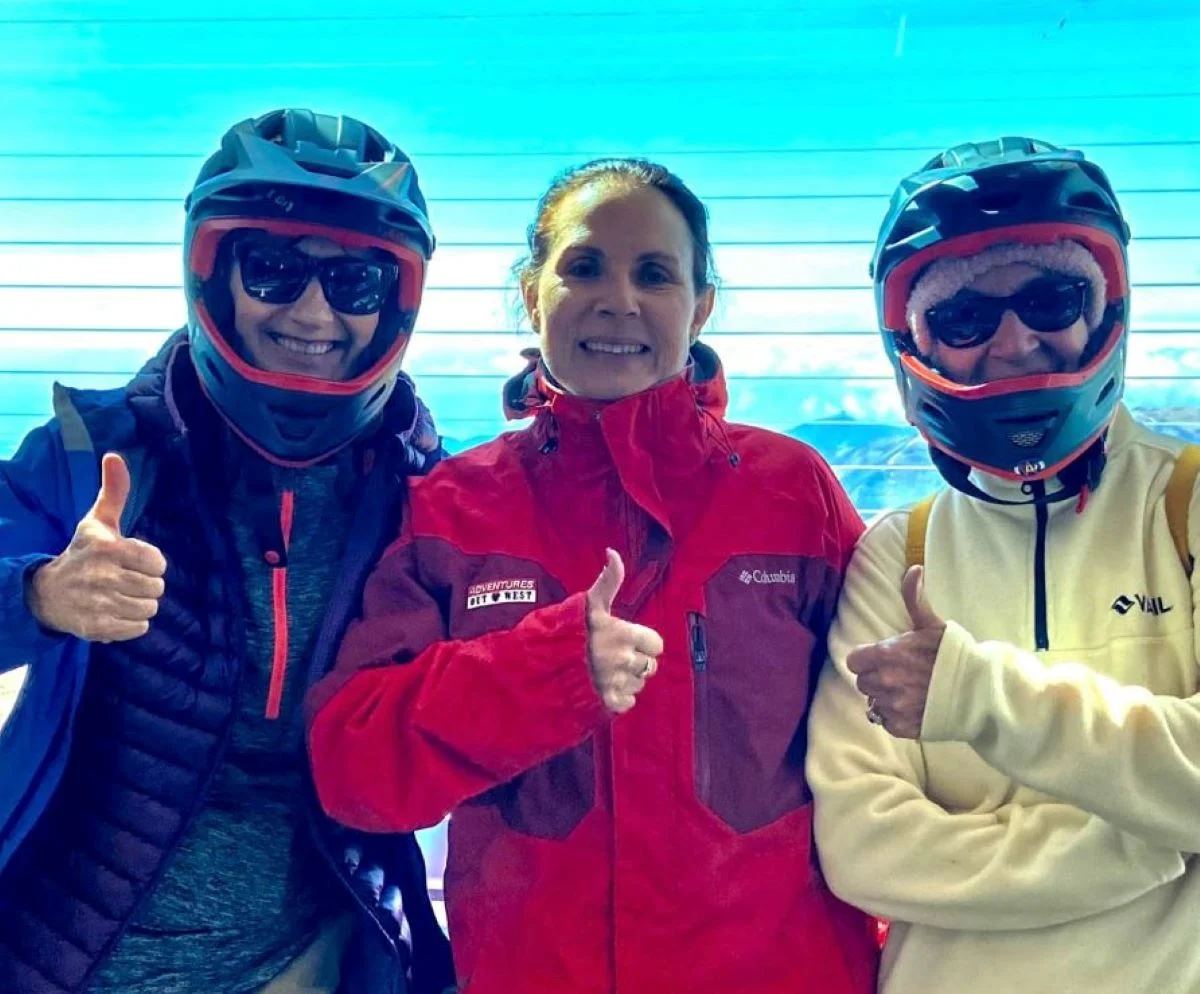 Three riders pose for a photo before they bicycle Pikes Peak.